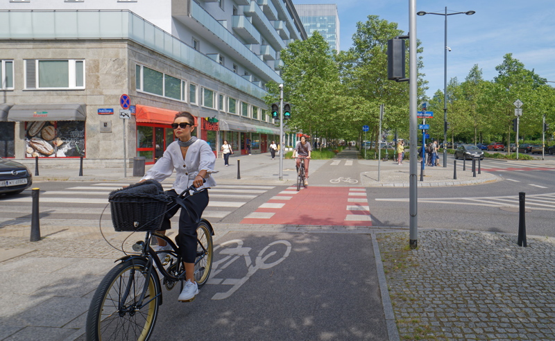 Woman bicycling in Warsaw 1
